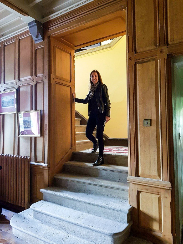 A person standing in front of a window Description automatically generated